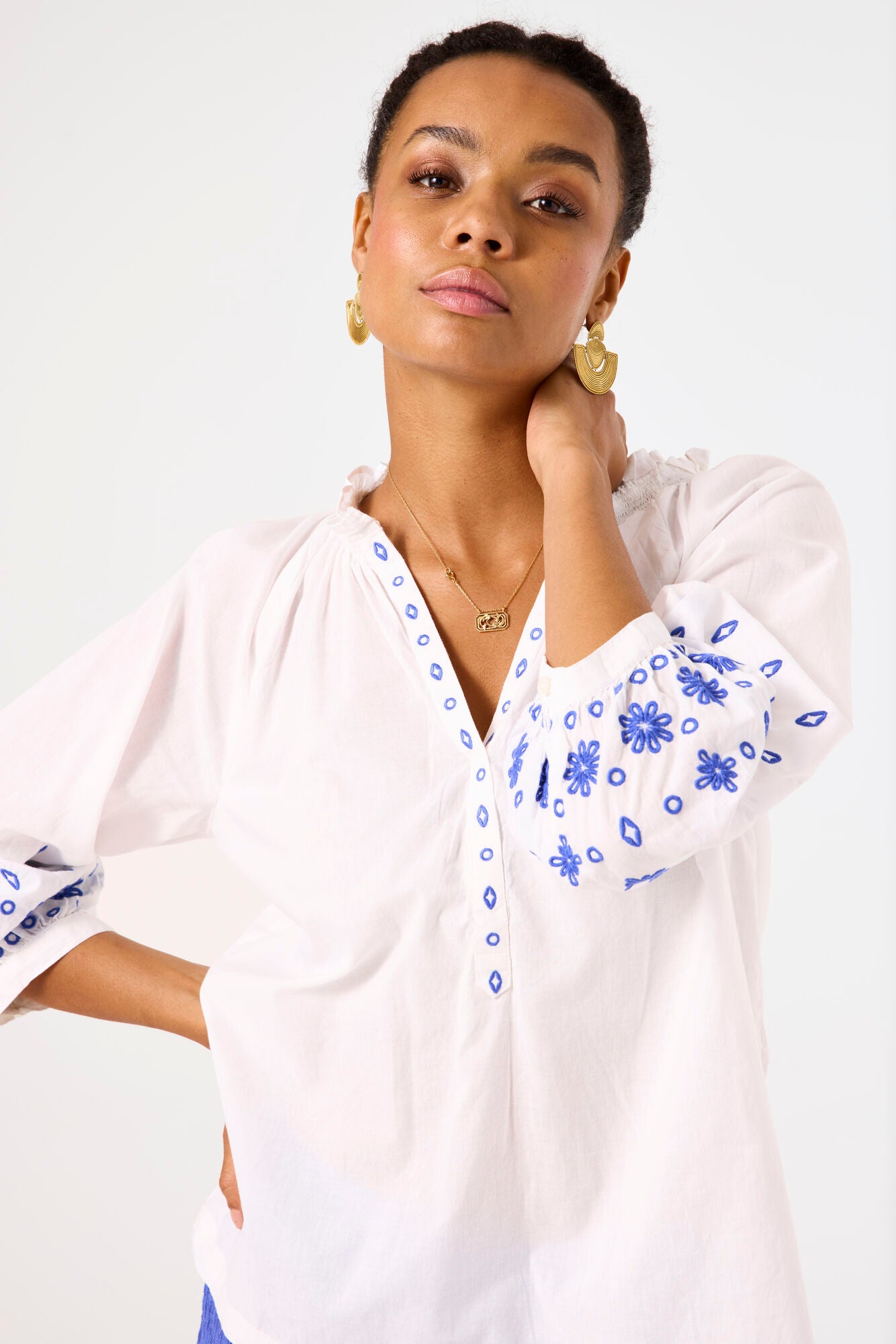 Garcia Ladies white top with blue embroidery detail.