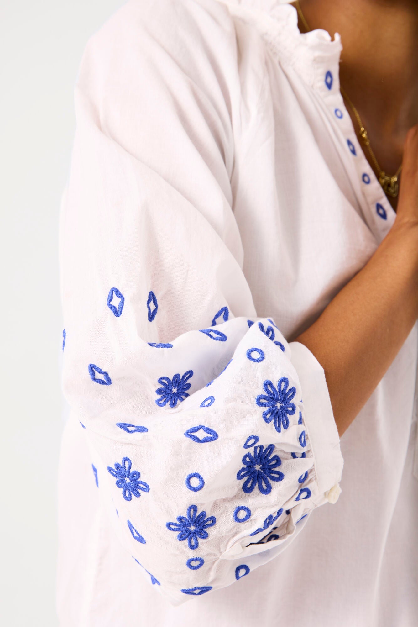 Garcia Ladies white top with blue embroidery detail.